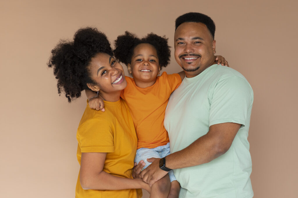 Happy family of three posing together indoors.