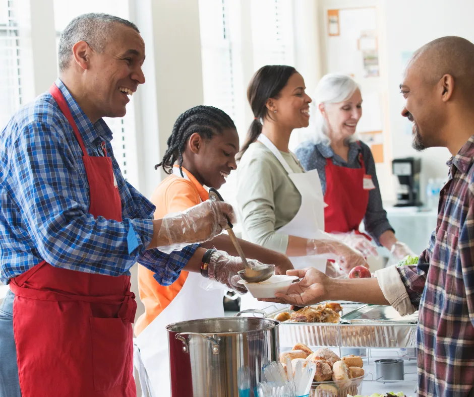 Volunteers serving food at a community kitchen.